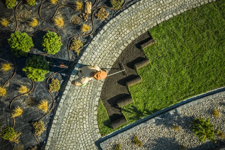 newly-build-backyard-garden-installing-500px Aerial view of Lawnmax installing fresh turf and creating garden enhancements with stone landscaping