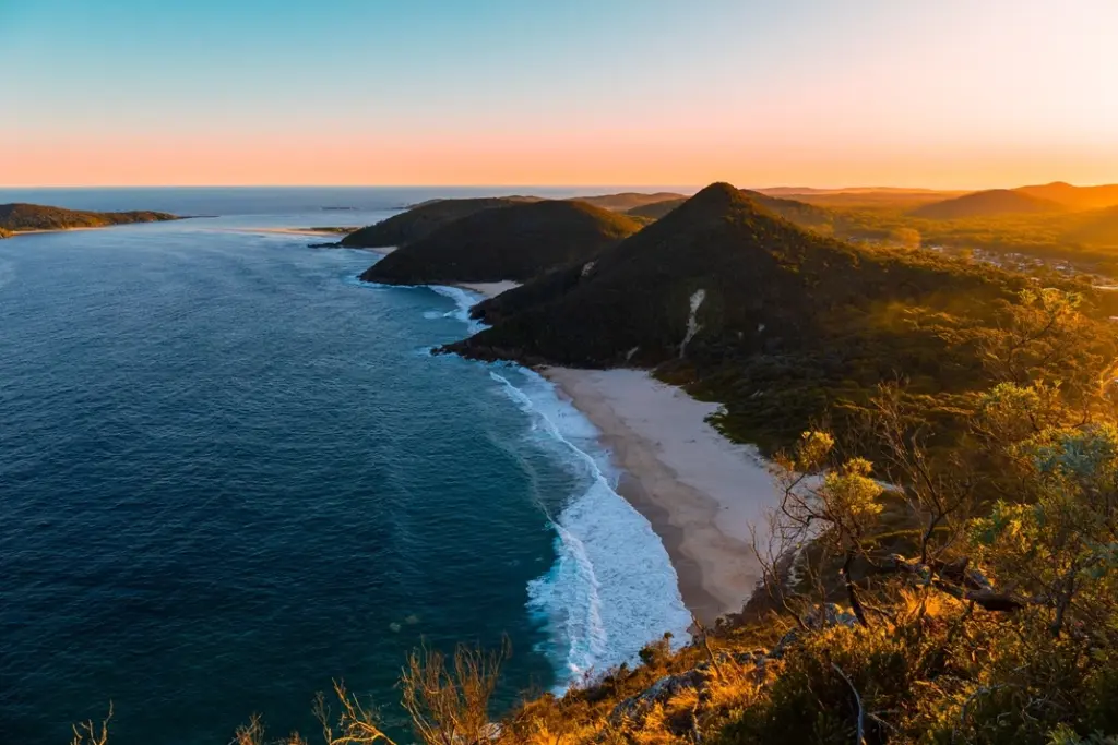 port-stephens-mt-tomaree Aerial view of Mt Tomaree and scenic coastline with beaches in Nelson Bay Port Stephens at sunset